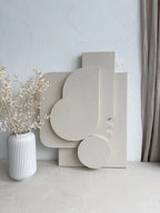Decorative white sculptures on a light surface with a neutral background