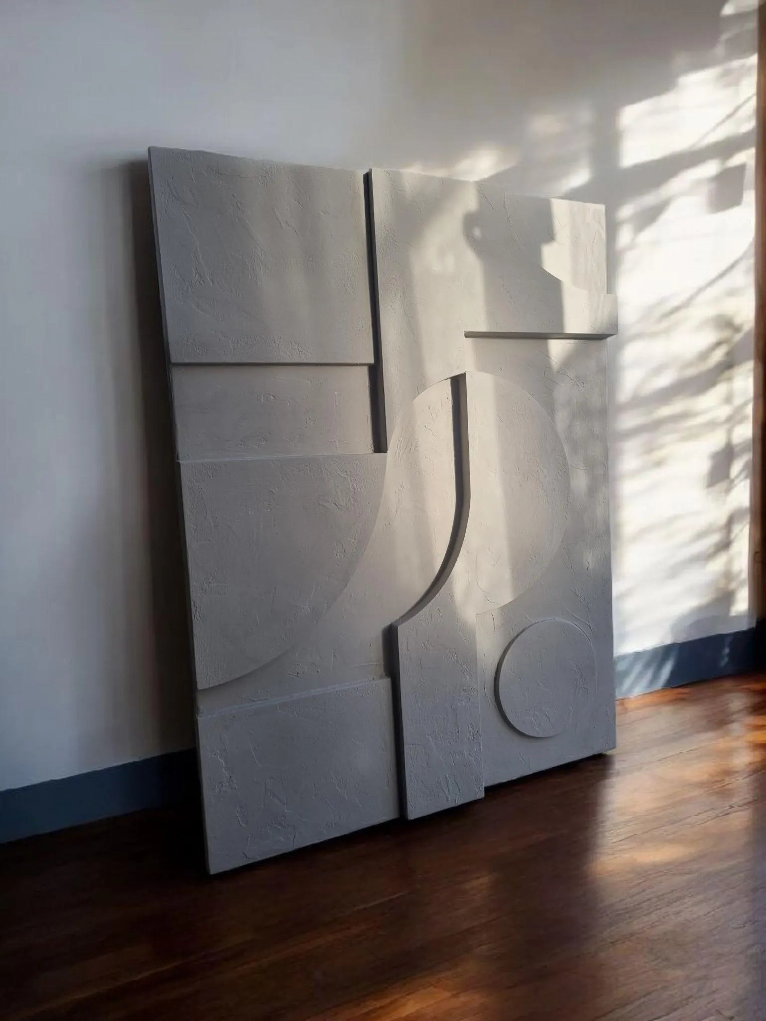 large neutral textured plaster wall art above sofa for contemporary home